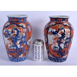 A PAIR OF 19TH CENTURY JAPANESE MEIJI PERIOD RIBBED VASES painted with landscapes. 26 cm high.
