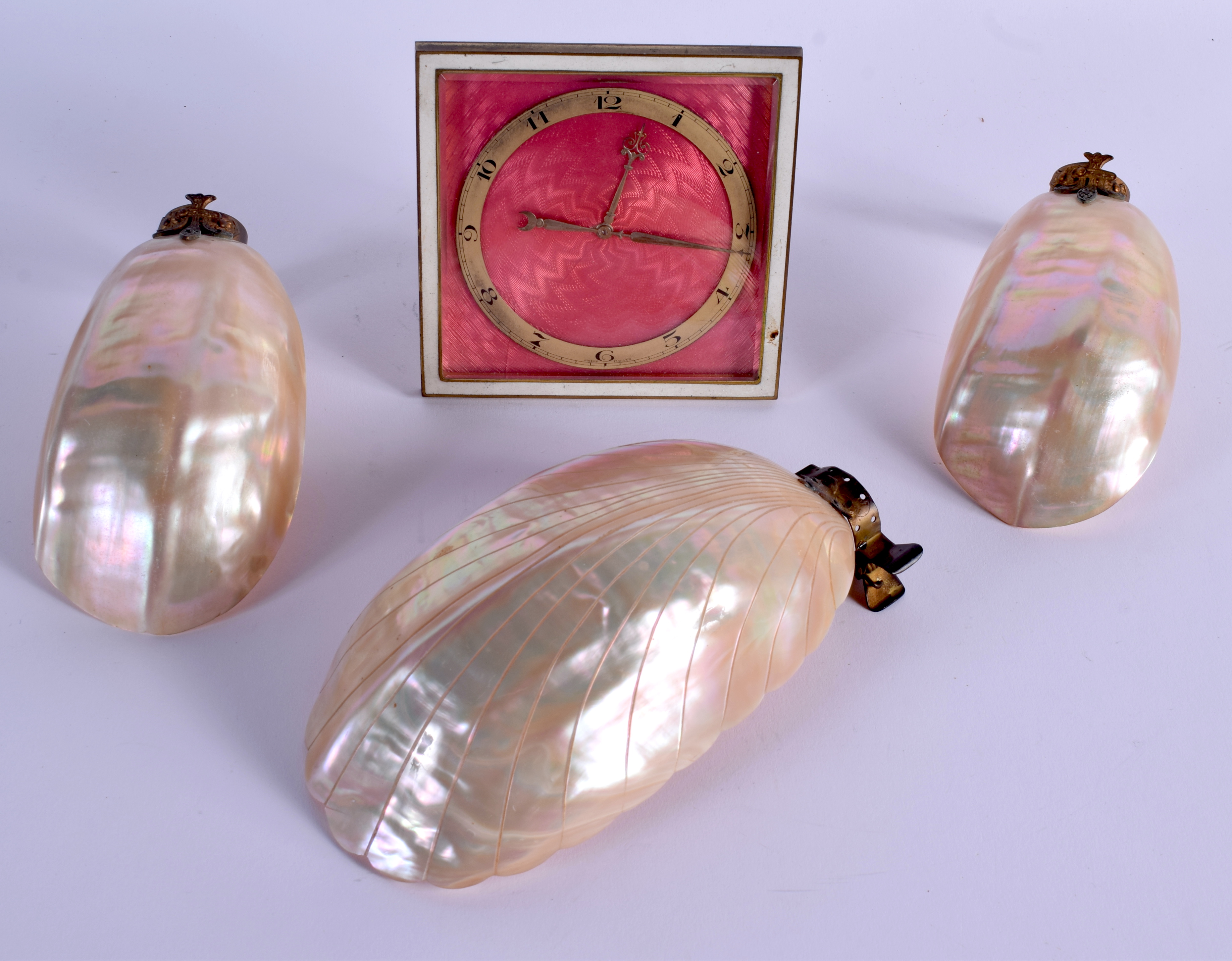 AN ART DECO EIGHT DAY ENAMEL CLOCK together with mother of pearl shell lights. (4)