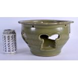 A RARE CHINESE QING DYNASTY INCISED CELADON OPEN WORK STONEWARE PLATER decorated with foliage and vi
