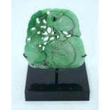 A Chinese carved Jade boulder on a stand 9 x 9cm.