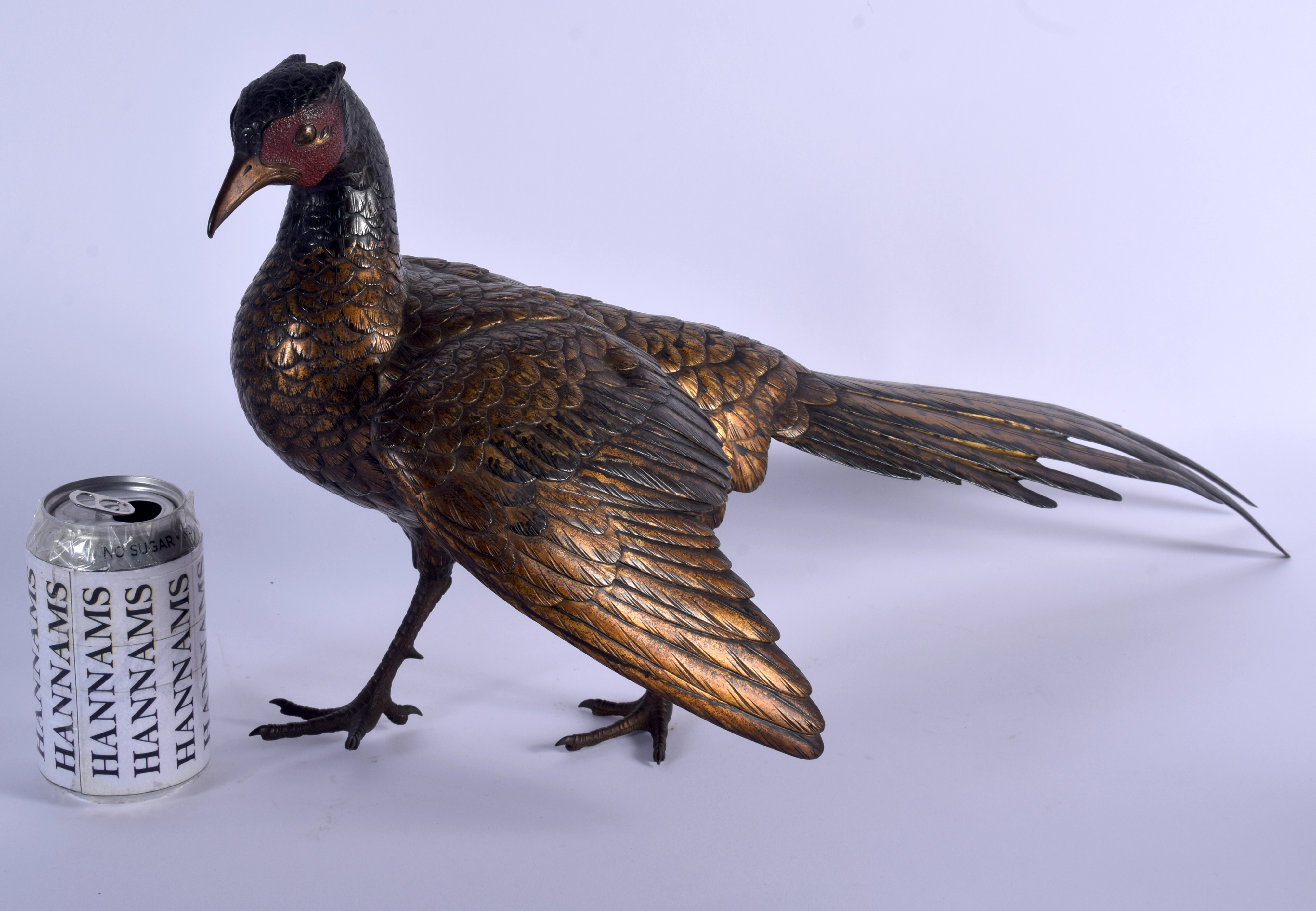 A 19TH CENTURY JAPANESE PATINATED BRONZE FIGURE OF A ROAMING PHEASANT of naturalistic form, modelled