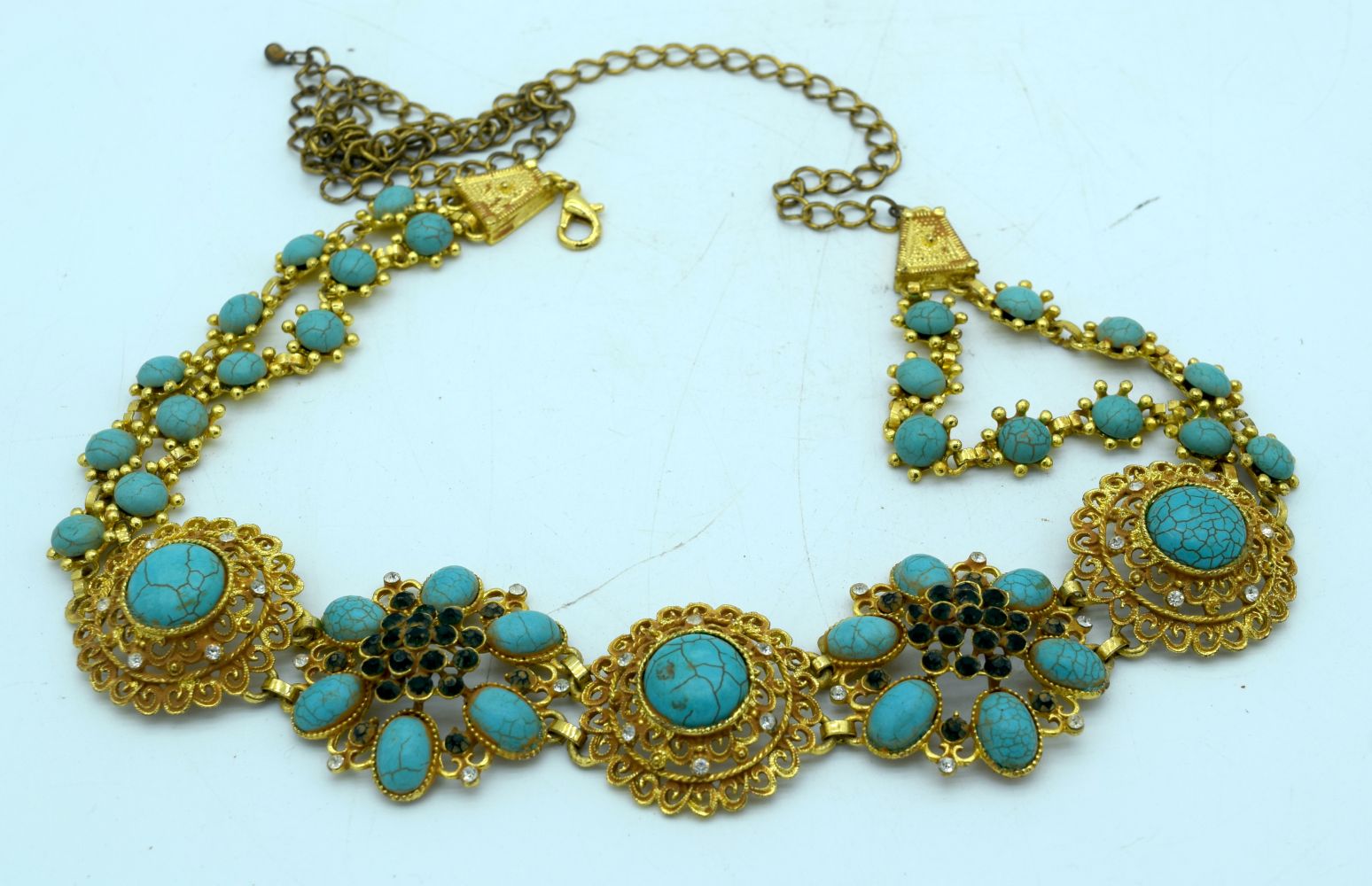 A Chinese Gilt metal belt with Turquoise stone inserts. 100 cm in length.