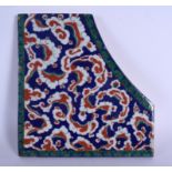 A LARGE TURKISH IZNIK FAIENCE GLAZED POTTERY FRAGMENTARY TILE painted with green and red flowers. 30