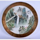 A CHINESE FAMILLE ROSE MOUNTAIN LANDSCAPE PLATE 20th Century. 35 cm diameter.