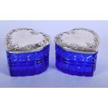 A PAIR OF SILVER HEART SHAPED BLUE GLASS BOXES AND COVERS. Silver 37 grams. 6.5 cm wide.