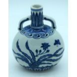 A small Chinese blue and white moon flask decorated with butterfly and foliage. 19cm.