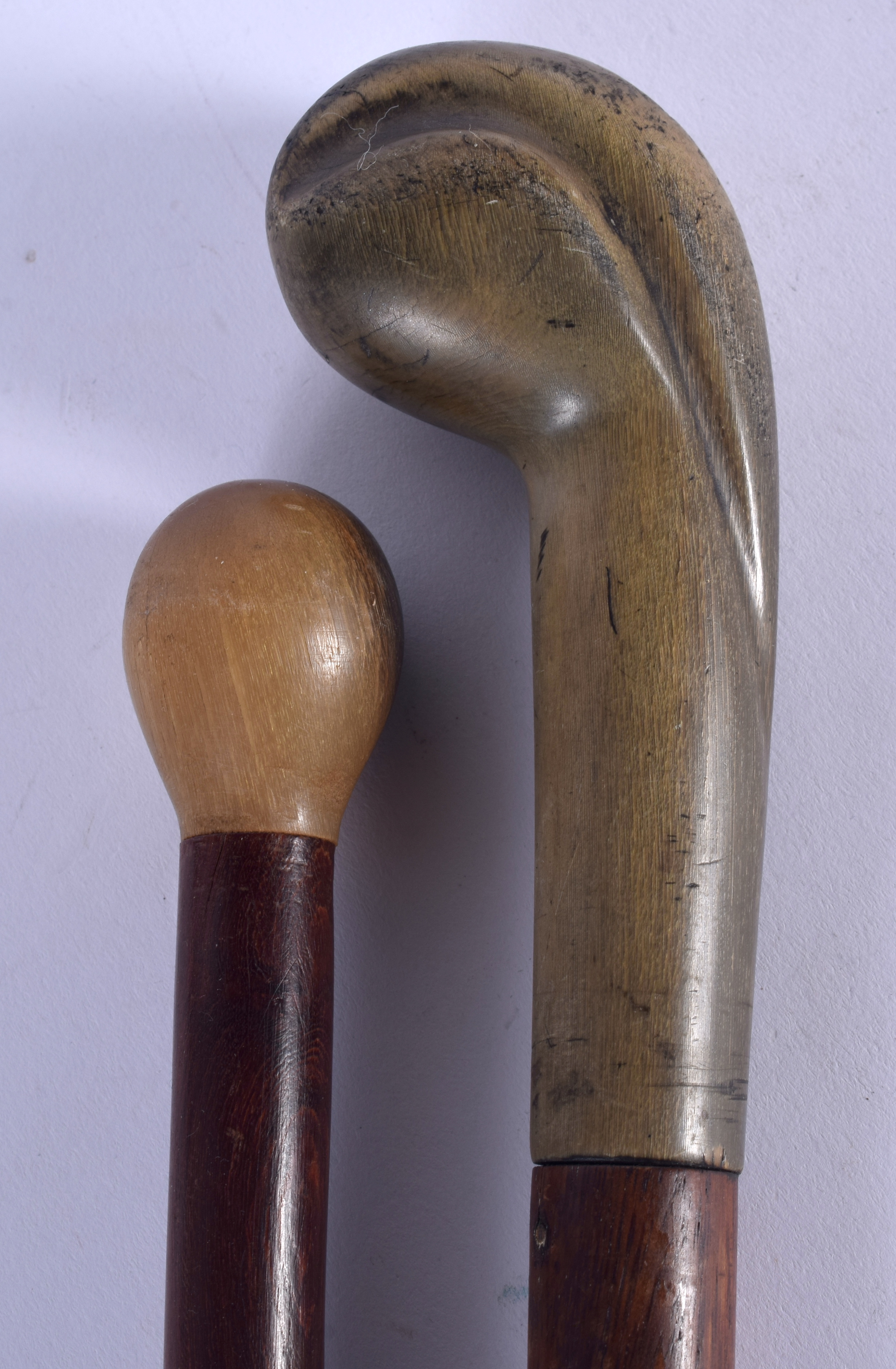 TWO 19TH CENTURY CONTINENTAL CARVED RHINOCEROS HORN HANDLED WALKING CANES. 88 cm long. (2)