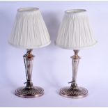 A PAIR OF ANTIQUE ENGLISH SILVER PLATED CANDLESTICKS converted to lamps. Sticks 31 cm high.