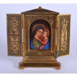 A 19TH CENTURY EUROPEAN BRONZE AND PORCELAIN ICON painted with a Madonna and child. 11 cm x 13 cm.