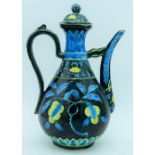 A Chinese wine pot decorated with yellow and blue flowers in relief 30cm.