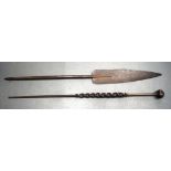 A 19TH CENTURY AFRICAN TRIBAL CARVED WOOD PADDLE together with another similar. 155 cm long. (2)