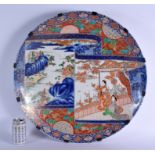 A VERY LARGE 19TH CENTURY JAPANESE MEIJI PERIOD CIRCULAR IMARI CHARGER painted with geisha and lands