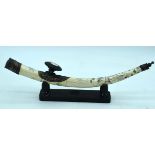 Chinese engraved bone opium pipe with a hardwood stand. 42cm.