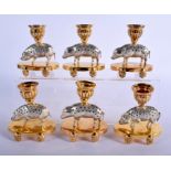 A CHARMING SET OF SIX ANTIQUE SILVER AND SILVER GILT CANDLESTICKS formed as roaming pigs upon oval b