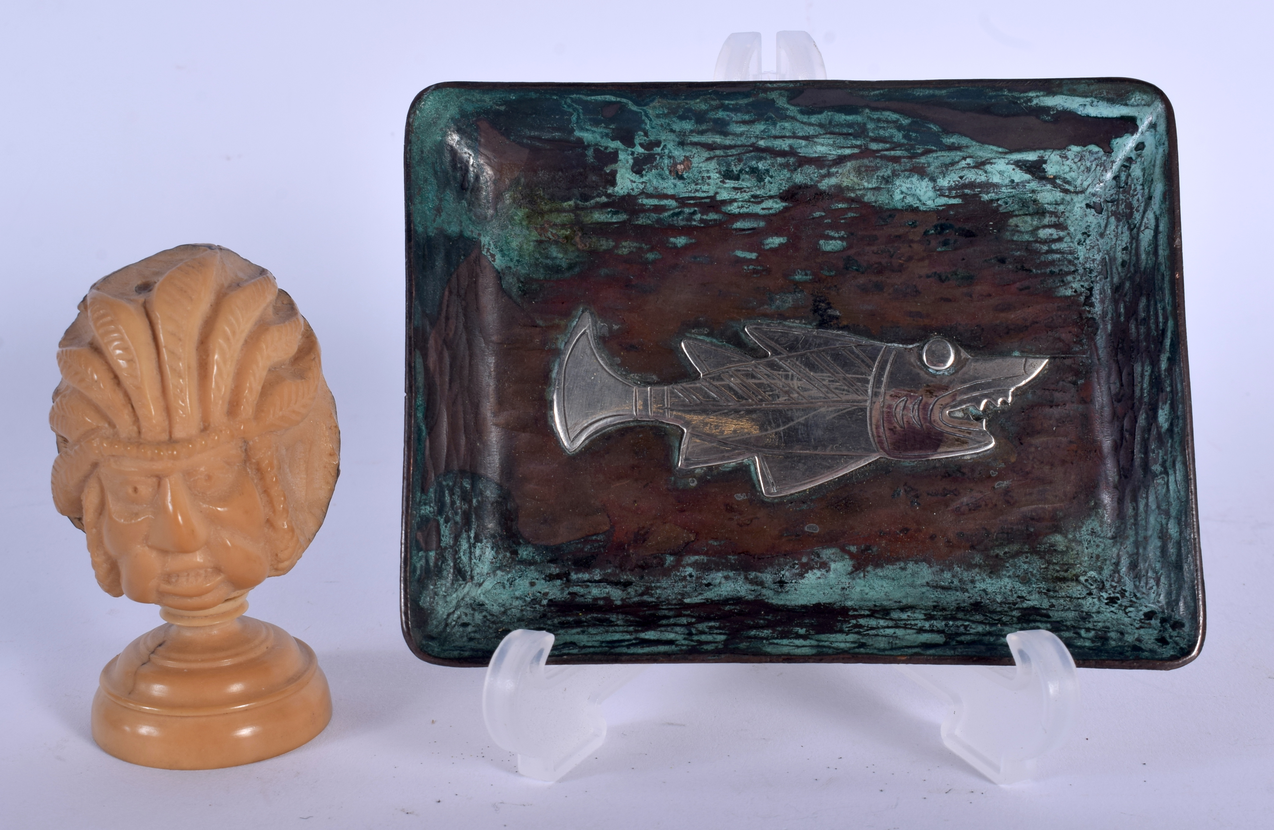 AN EARLY 20TH CENTURY CARVED TAGUA NUT INDIAN CHIEF together with a silver inlaid dish. Largest 10.5