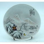 A Chinese plate celebrating 1973 decorated with a snowy landscape 23cm.