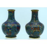 A PAIR OF 19TH CENTURY CHINESE CLOISONNE ENAMEL VASES decorated with foliage and vines. 12 cm high.