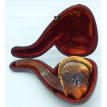 AN ANTIQUE MEERSCHAUM AND AMBER BEARDED MALE PIPE. 12 cm wide.