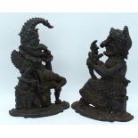 A PAIR OF LATE VICTORIAN CAST IRON PUNCH AND JUDY DOOR STOPS modelled upon shaped bases. 32 cm x 14