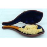 AN ANTIQUE MEERSCHAUM AND AMBER ROAMING BULL PIPE modelled upon a floral capped stem. 17 cm wide.