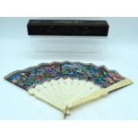 A MID 19TH CENTURY CHINESE CANTON PAINTED IVORY FAN decorated with figures within landscapes. 50 cm