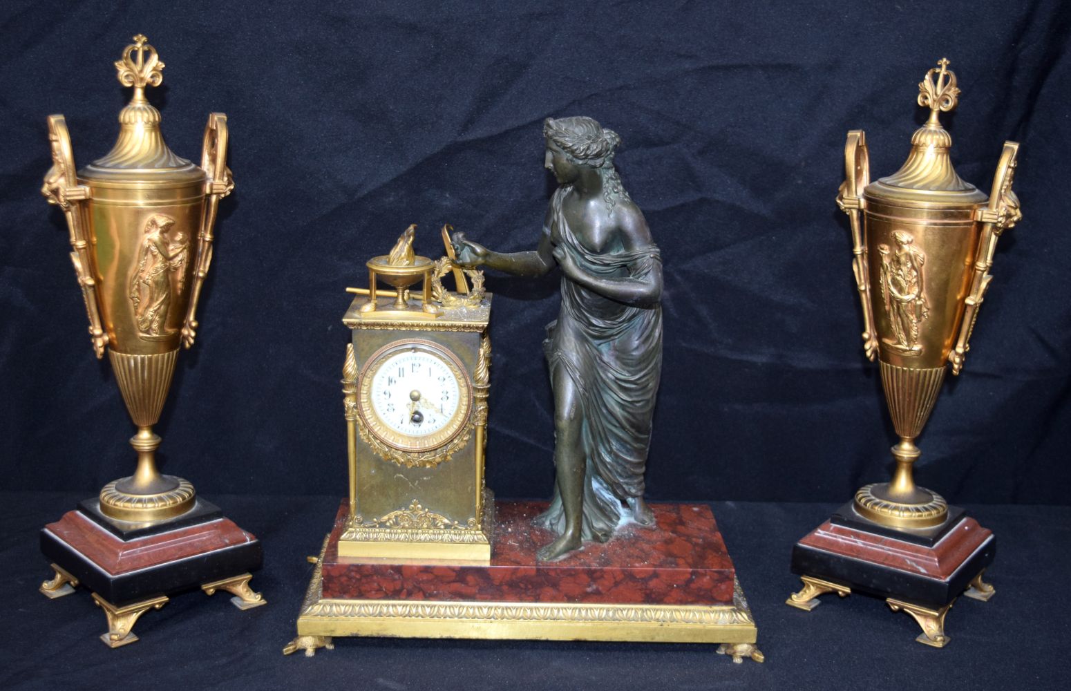 A LARGE 19TH CENTURY FRENCH BRONZE AND RED MARBLE CLOCK GARNITURE. 37Cm high (3).