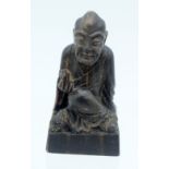 A 19TH CENTURY CHINESE CARVED RHINOCEROS HORN SEAL Qing, modelled as a seated buddha in flowing robe