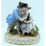 AN ANTIQUE GERMAN PORCELAIN FIGURAL GROUP modelled as a boy and girl playing a pipe. 13 cm x 11 cm.