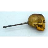 A RARE 19TH CENTURY CARVED MEERSCHAUM AND AMBER PIPE formed as an inscribed skull. 12.5 cm wide.