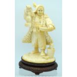 AN EARLY 20TH CENTURY CHINESE CARVED CULTURAL REVOLUTION IVORY modelled roaming holding grain holdin