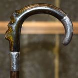 A 19TH CENTURY CONTINENTAL CARVED RHINOCEROS HORN WALKING CANE with silver mounts. 67 cm long.