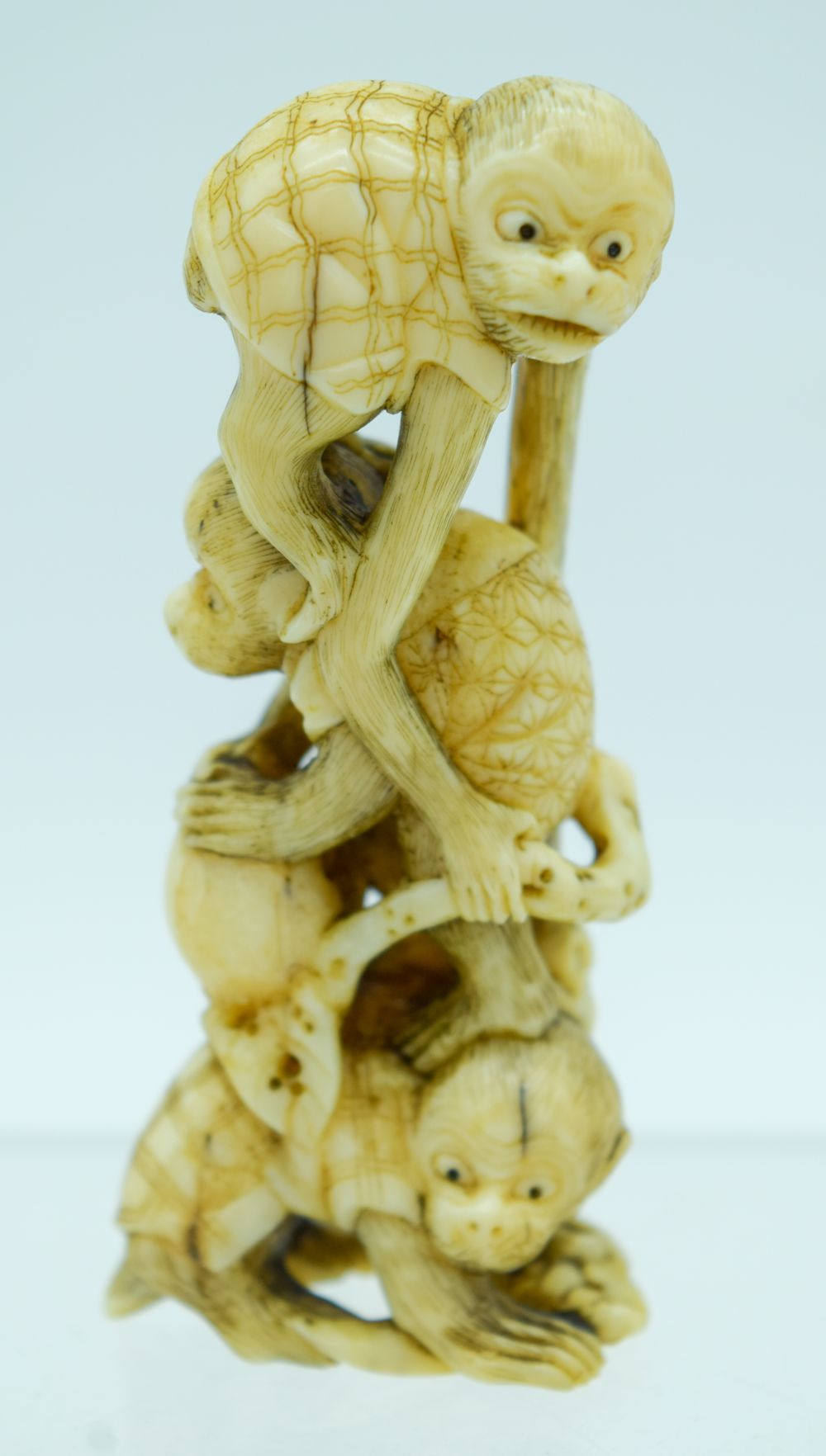 A 19TH CENTURY JAPANESE MEIJI PERIOD CARVED IVORY OKIMONO modelled as numerous monkeys. 9 cm high.