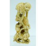 A 19TH CENTURY JAPANESE MEIJI PERIOD CARVED IVORY OKIMONO modelled as numerous monkeys. 9 cm high.