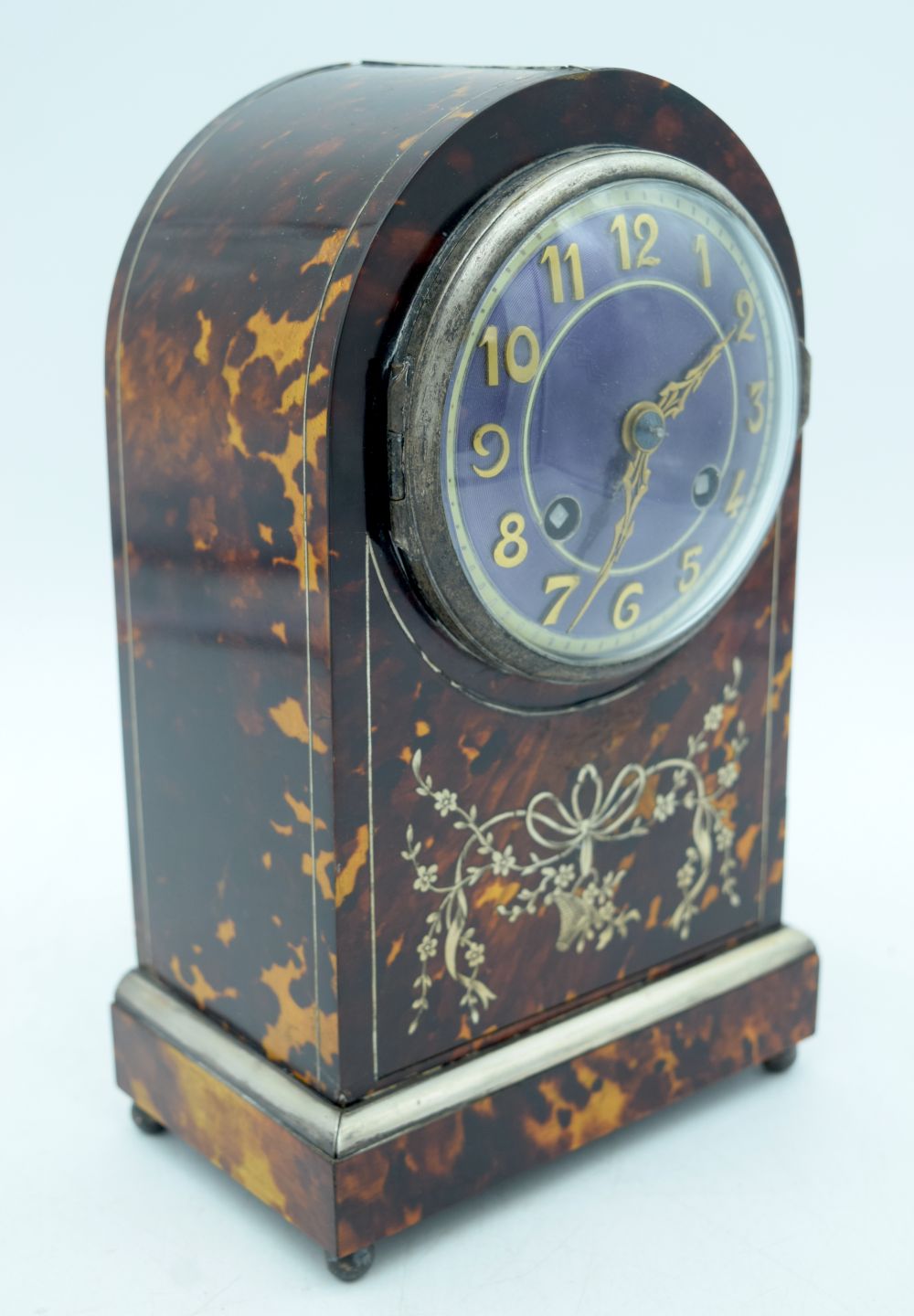 A RARE 19TH CENTURY ENGLISH SILVER AND TORTOISESHELL MANTEL CLOCK, with a purple enamel dial. 23 cm