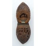 AN EARLY 19TH CENTURY EUROPEAN CARVED COQUILLA DOUBLE NUT SNUFF BOX decorated with figures and lands