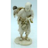 A FINE 19TH CENTURY JAPANESE MEIJI PERIOD CARVED IVORY OKIMONO modelled as a male holding a crab. 16