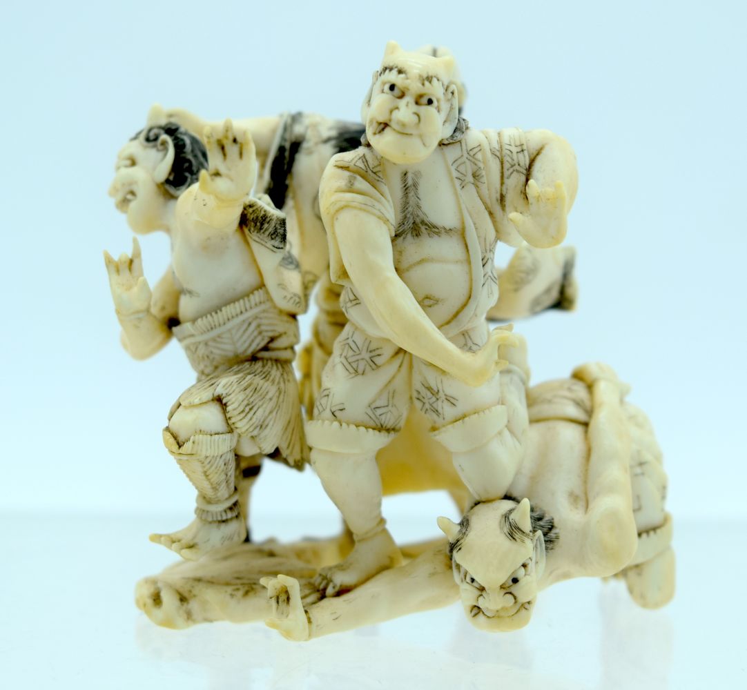 A 19TH CENTURY JAPANESE MEIJI PERIOD CARVED IVORY OKIMONO modelled as numerous oni in various pursui - Bild 3 aus 6