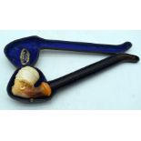AN ANTIQUE MEERSCHAUM AND AMBER FEMALE PORTRAIT HEAD PIPE. 26 cm wide.