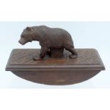 A LATE 19TH CENTURY BAVARIAN BLACK FOREST DESK BLOTTER in the form of a roaming bear. 14 cm x 9 cm.