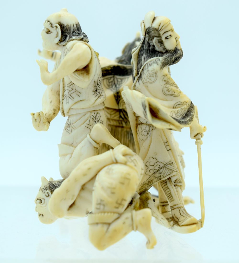 A 19TH CENTURY JAPANESE MEIJI PERIOD CARVED IVORY OKIMONO modelled as numerous oni in various pursui - Bild 2 aus 6