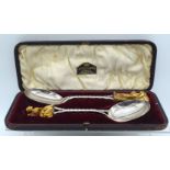 A RARE PAIR OF 19TH CENTURY JAPANESE MEIJI PERIOD CARVED IVORY HANDLED SERVING SPOONS with silver pl