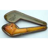 AN ANTIQUE MEERSCHAUM AND AMBER MONKEY HEAD PIPE. 14 cm wide.