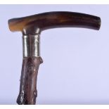 A 19TH CENTURY CONTINENTAL CARVED RHINOCEROS HORN HANDLED WALKING CANE. 88 cm long.