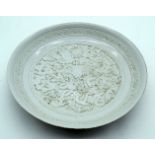A Chinese dish decorated with dragons in relief 5 x 28 cm.