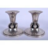 A PAIR OF STERLING SILVER GEORG JENSEN TYPE CANDLESTICKS. 370 grams. 11 cm x 7 cm.