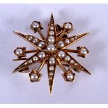 A VICTORIAN 15CT GOLD STAR BROOCH. 5 cm wide.