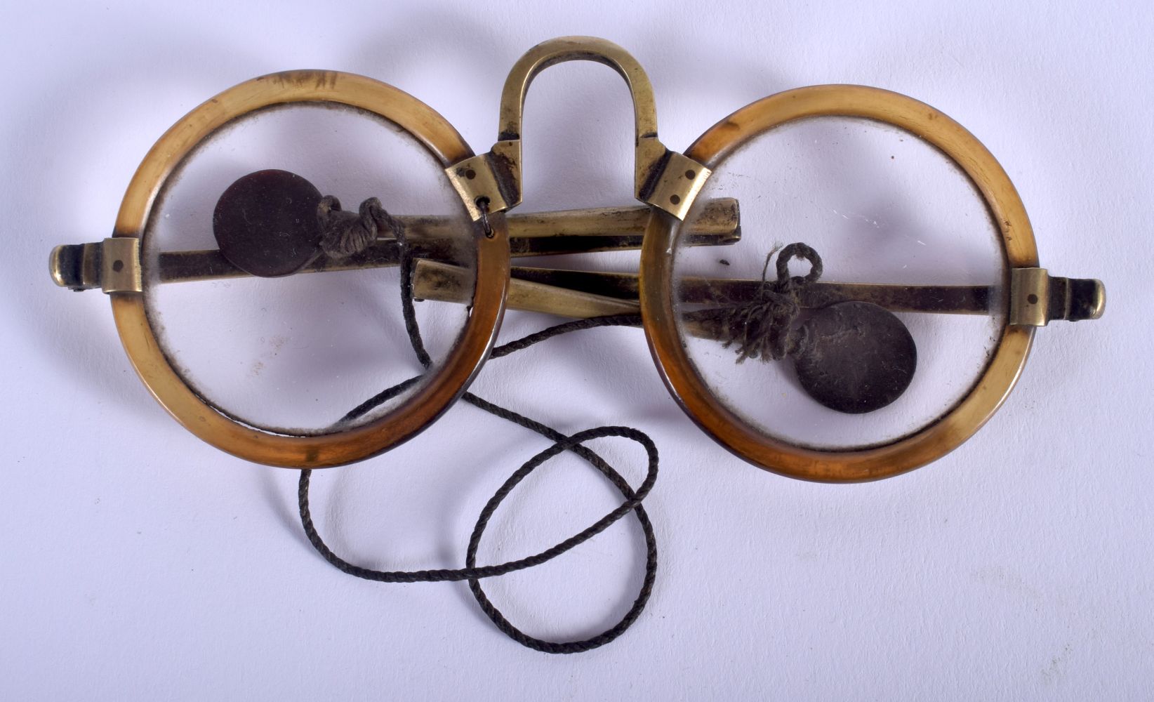 A RARE PAIR OF EARLY 20TH CENTURY CHINESE CARVED RHINOCEROS HORN SPECTACLES with folding arms. 14 cm