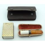 An amber Cheroot holder with a silver collar together with a leather coin case and a vesta case.12cm