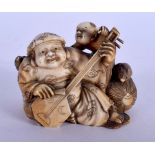 A 19TH CENTURY JAPANESE MEIJI PERIOD CARVED IVORY OKIMONO modelled as a musician. 5 cm x 4.5 cm.
