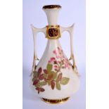 Royal Worcester two handled vase of Eastern inspiration painted with flowers on an ivory ground. c.
